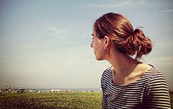 Girl looking out people on beach